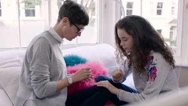 Mom helping daughter paint nails