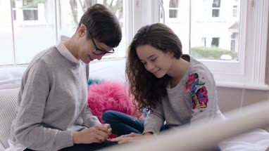 Mom helping daughter paint nails