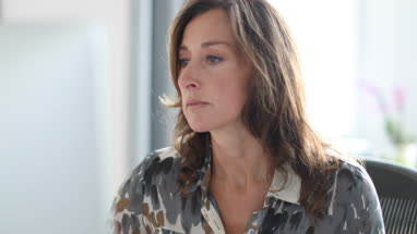 Mature business woman working on desktop computer