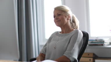 Mature business woman working on desktop computer