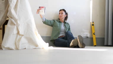 Mature female looking at colour card