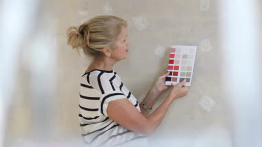 Mature female looking at colour card