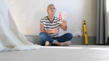 Mature female looking at colour card