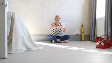 Mature female looking at colour card