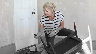 Mature female repairing an old chair