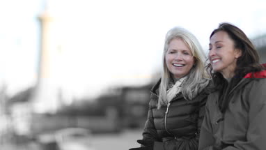 Mature female friends looking out to sea