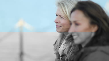 Mature female friends looking out to sea