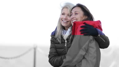 Mature female friends looking out to sea