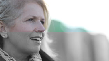 Mature female outdoors looking at view