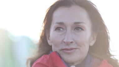 Mature female outdoors looking at view