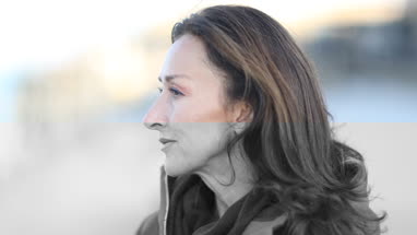 Mature female outdoors looking at view