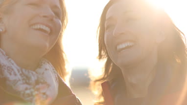 Mature female friends laughing outdoors