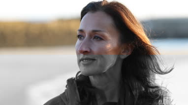 Mature female outdoors looking to camera