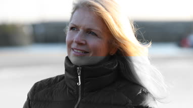 Mature female outdoors looking to camera