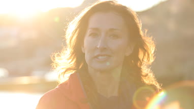 Mature female outdoors looking to camera