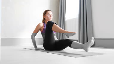 Young adult female doing yoga at home