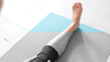 Young adult female doing yoga at home