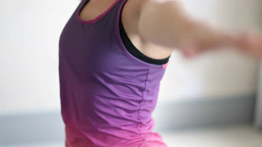 Young adult female doing yoga at home