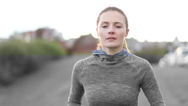 Young adult female jogging outdoors