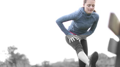 Young adult female stretching on bench