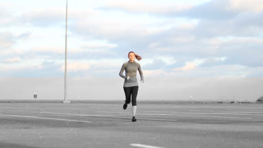 Young adult female jogging outdoors