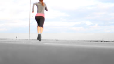 Young adult female jogging outdoors