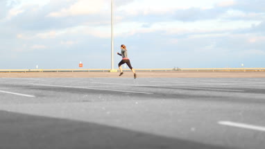 Young adult female jogging outdoors
