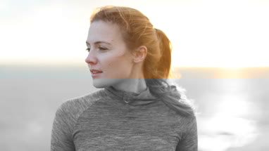 Sporty young adult female looking to camera