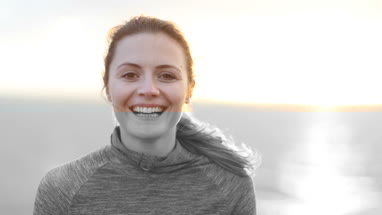 Sporty young adult female looking to camera