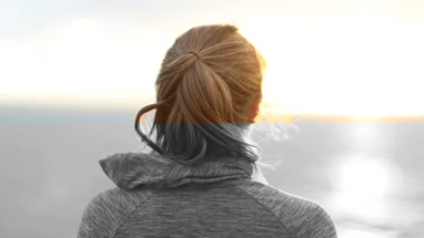 Sporty young adult female looking to camera