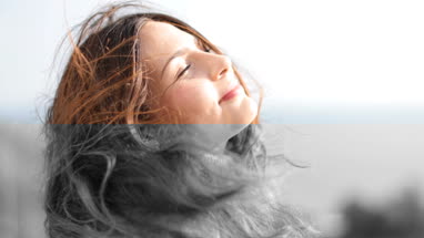 Carefree woman with wind in her hair