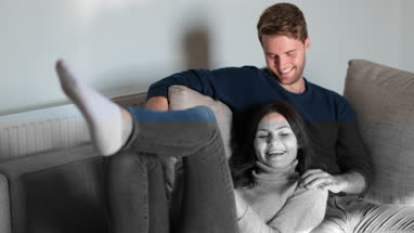 Couple relaxing on sofa at home
