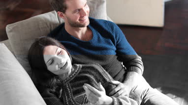 Couple relaxing on sofa at home