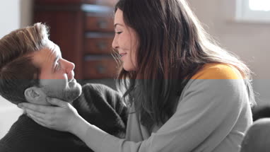 Couple at home talking and laughing