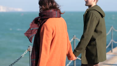 Couple in love walking by coastline