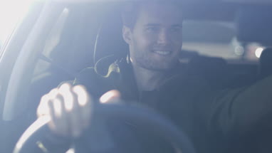 Driver adjusting rear view mirror 
