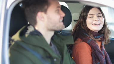 Couple singing in car stuck in traffic