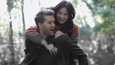Couple having fun in forest in Fall