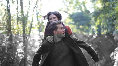 Couple having fun in forest in Fall