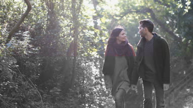 Couple walking in forest in Fall