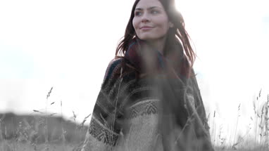 Woman walking in cornfield in fall
