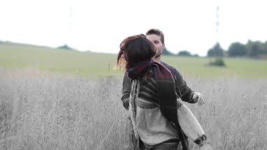 Couple walking in cornfield in fall
