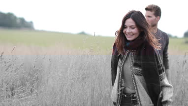 Couple walking in cornfield in fall