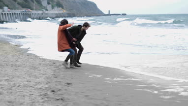 Couple being playful on beach