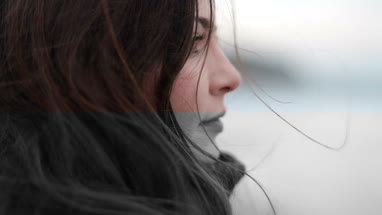 Woman looking thoughtfully out to sea