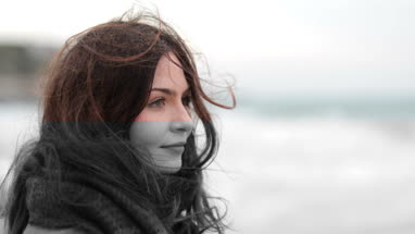 Woman looking thoughtfully out to sea