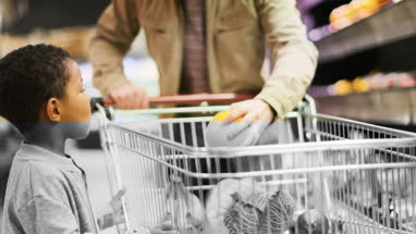 Father and son buying fruit and vegetable in grocery store