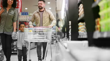 Family doing weekly shop in grocery store
