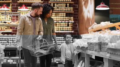 Family buying bread in grocery store