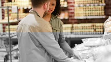 Shoppers in supermarket at the bakery